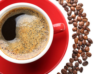 A red cup of tasty drink and scattered coffee grains, isolated on white, top view