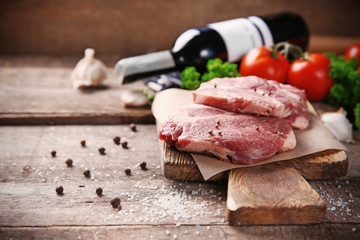 Marbled beef steak and spices on wooden background