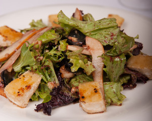 Salad with meat and lettuce on a plate in a restaurant