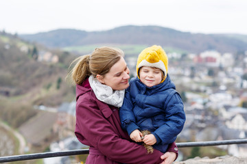  little child and young mother enjoying view city from above