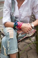 Stylish girl in denim overalls and a shirt with a bag
