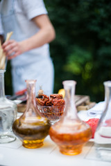Obraz na płótnie Canvas Chef's table with vessels for oil, vinegar, water