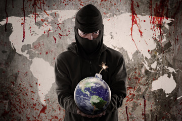 Portrait of man holding bomb with world map
