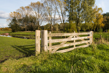 Hardwood gate between wooden posts in a rural area