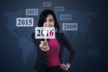 Woman touching number 2016 on the virtual screen
