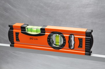 Construction tool spirit level on line of metal profile