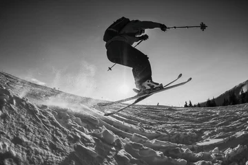 Foto auf Acrylglas black and white shot of free skier jumping © catgrig
