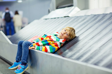 little tired kid boy at the airport, traveling