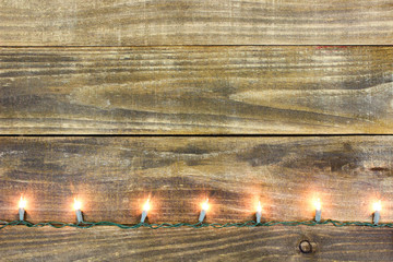 Blank rustic wood sign with string of holiday lights border