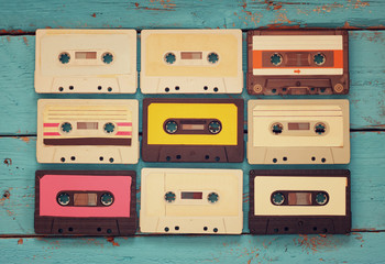 close up photo of vintage cassette tape over aqua wooden table . top view. retro filtered
