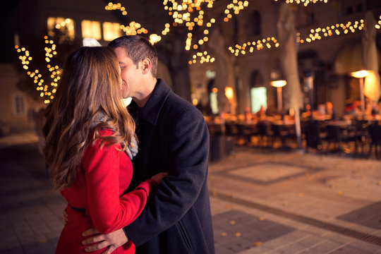 young loving couple kissing in the city center