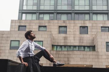 Handsome Indian man posing in an urban context