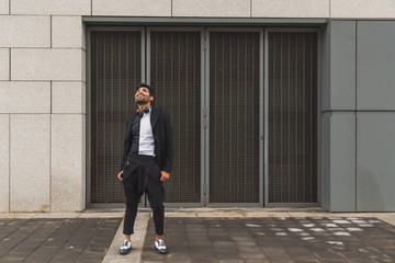 Handsome Indian man posing in an urban context