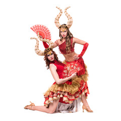 Two women dancers with horns. Isolated on white background.