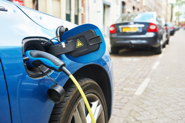 power supply plugged into an electric car during charging