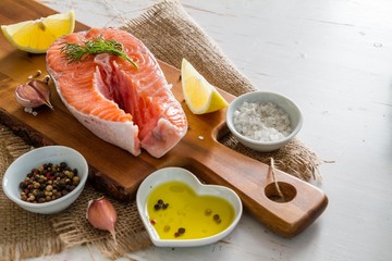 Salmon steak with lemon slices and spices