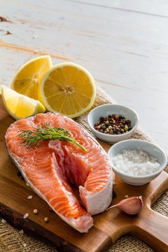 Salmon steak with lemon slices and spices