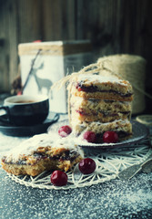 Cake with cherries and a cup of coffee