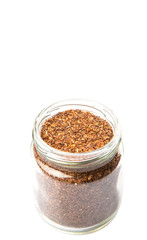 Obraz na płótnie Canvas Dried rooibos herbal tea leaves in mason jar over white background