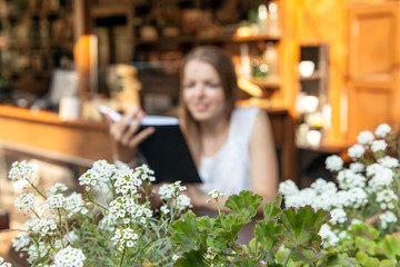 girl sitting at summer terrace and reading book