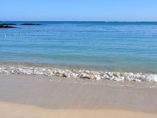 Wave on a sandy beach on Mauritius