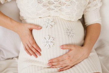 Anticipation. Belly with white snowflakes