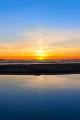 Multicolored summertime sunset on Baltic sea beach. Vertical out