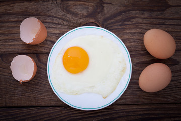 Fried eggs breakfast bachelor on wooden table