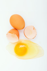 Broken egg on white background