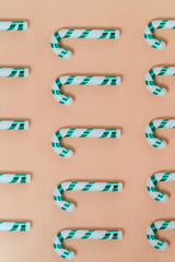 Christmas candy canes on color background with long shadow