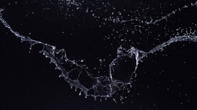 Water splash in midair against black background. Shot with high speed camera, phantom flex 4K. Slow Motion. Unedited version is included at the end of clip.