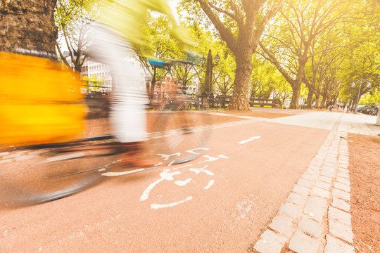 Fototapeta Blurred rider cycling on bike lane in Dusseldorf