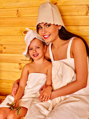 Family with child relaxing at sauna.