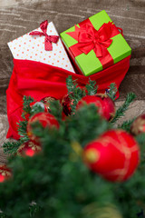 Christmas background with decorations and gift boxes on wooden b