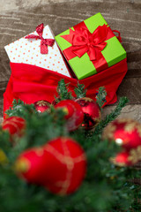 Christmas background with decorations and gift boxes on wooden b
