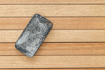 Top view broken of smart phone on wooden table