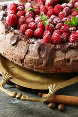 Cake with Chocolate Glaze and raspberries on wooden background