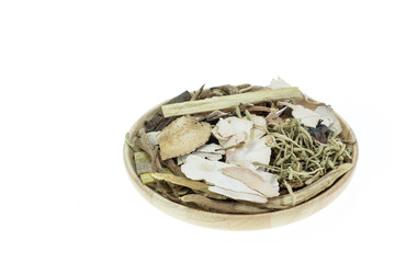 Mix of chinese herbal medicine in wooden dish isolated on white