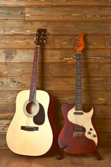Naklejka premium Electric and acoustic guitars on wooden background