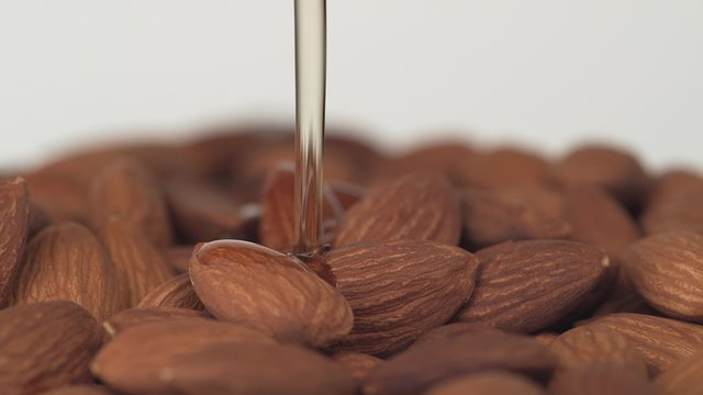 Pouring oil on almonds. Shot with high speed camera, phantom flex 4K.  Slow Motion. 