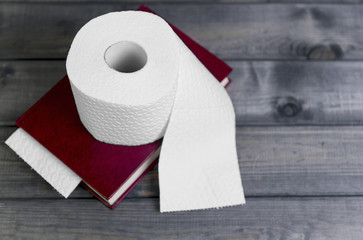 hardcover red cover to read and white embossed roll of toilet pa