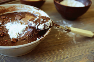 Preparing dough for chocolate pie on table close up