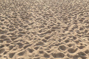 foot prints on sand at the beach in the afternoon