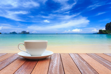 White coffee cup on wood table and view of nature background
