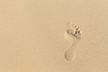 foot prints on sand at the beach in the afternoon