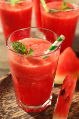 Glasses of watermelon juice on wooden table, closeup