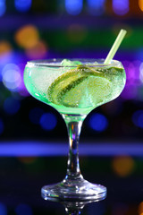 Glass of cocktail on bar background
