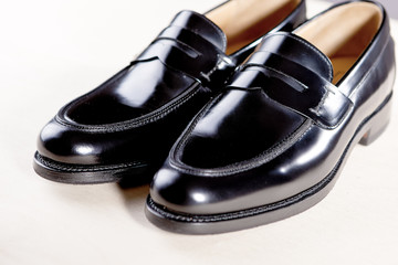 Obraz na płótnie Canvas Pair of Stylish Expensive Modern Leather Black Penny Loafers Shoes