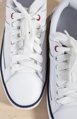 Fashion Concept and Ideas. Closeup of Pair of White Fashionable Plimsoles