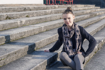 Portrait of Smiling Teenage Caucasian Girl on Stairs